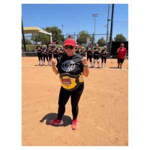 Head Coach posing with champion belt